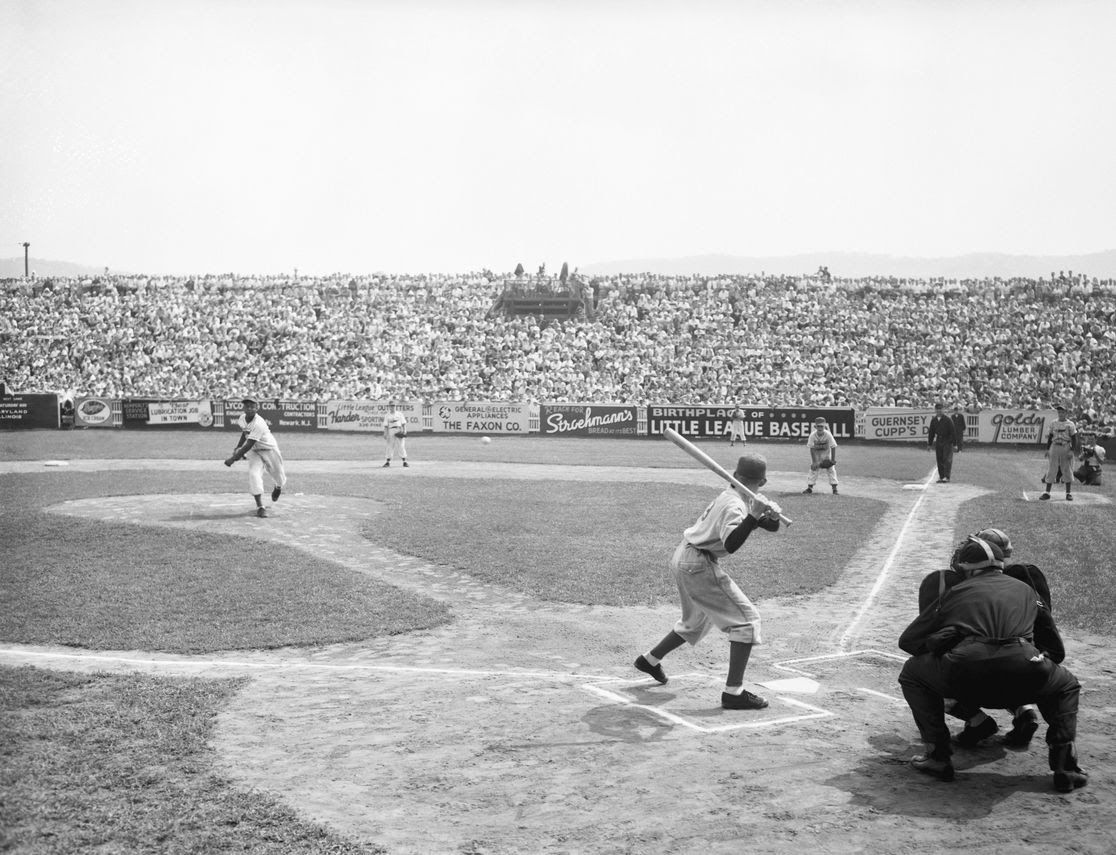 A baseball game. History of Youth Sports in the US