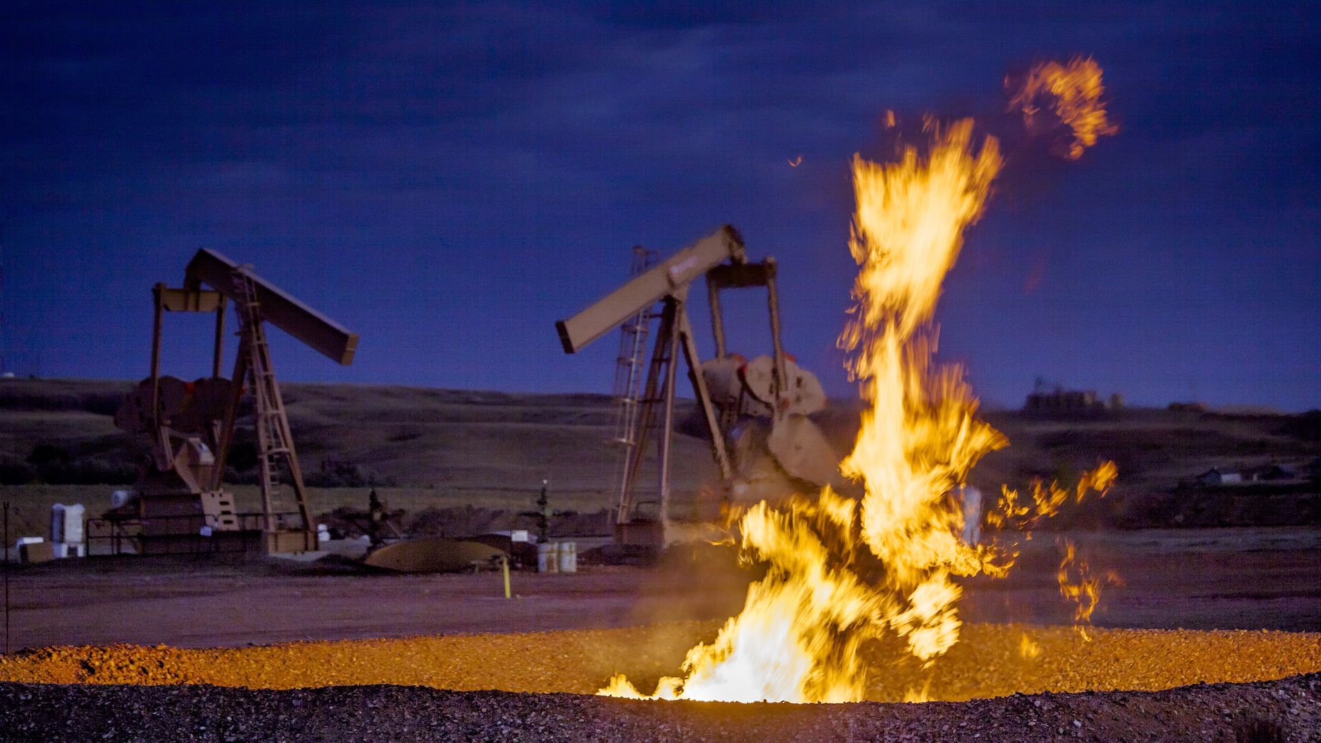 Natural gas flaring at a drill site.