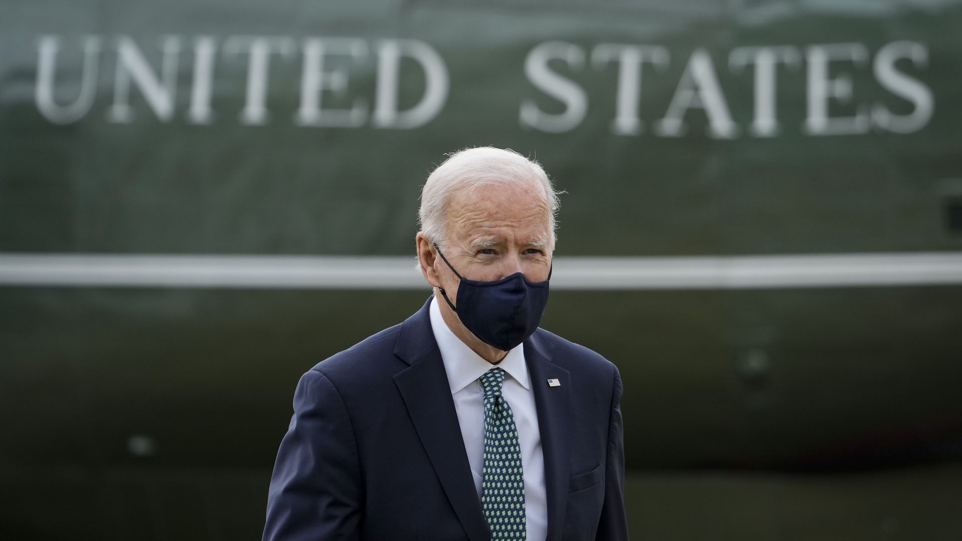 President Biden is seen walking in front of the "United States" lettering on Marine One.