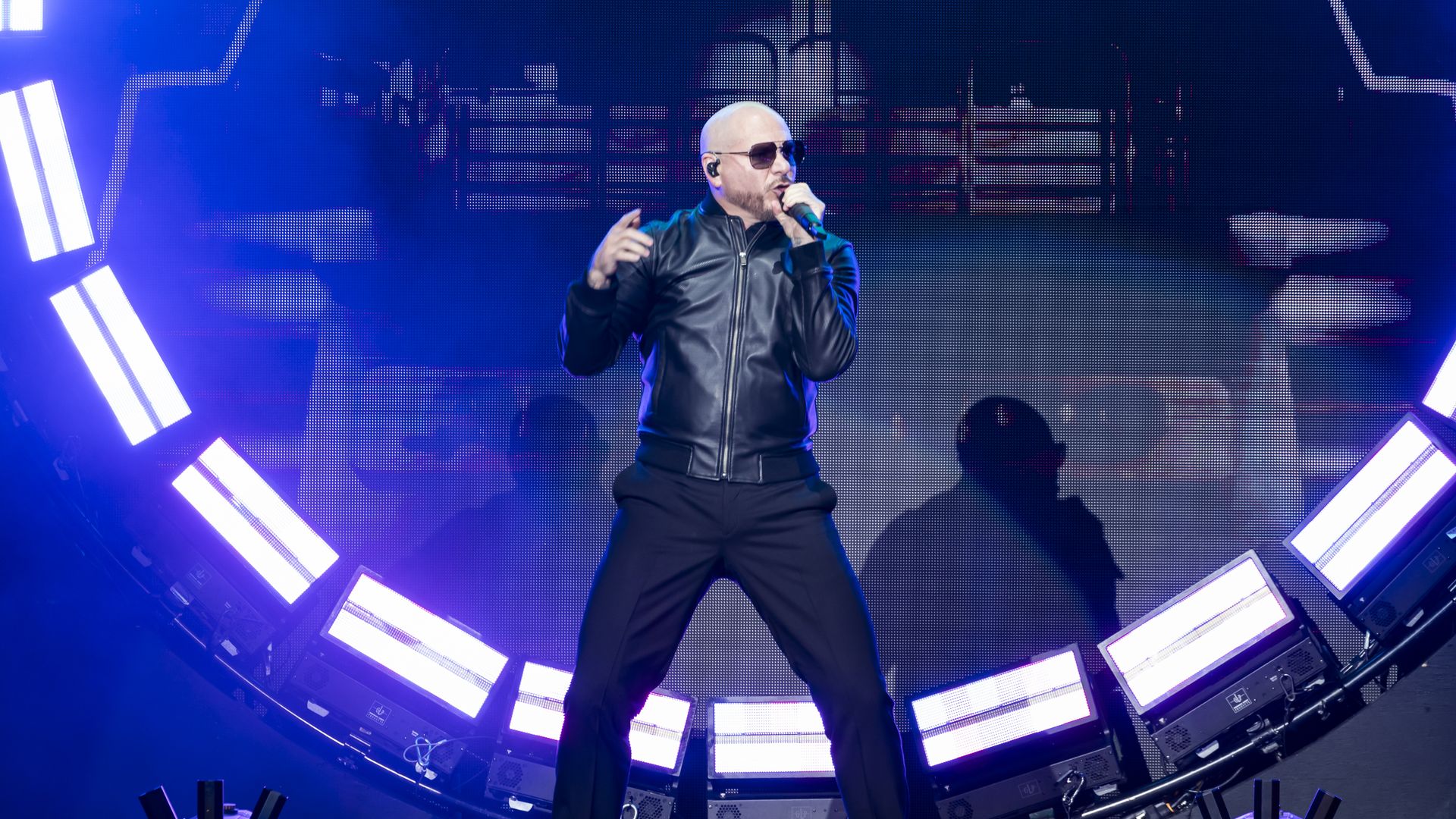 Pitbull performing on stage.