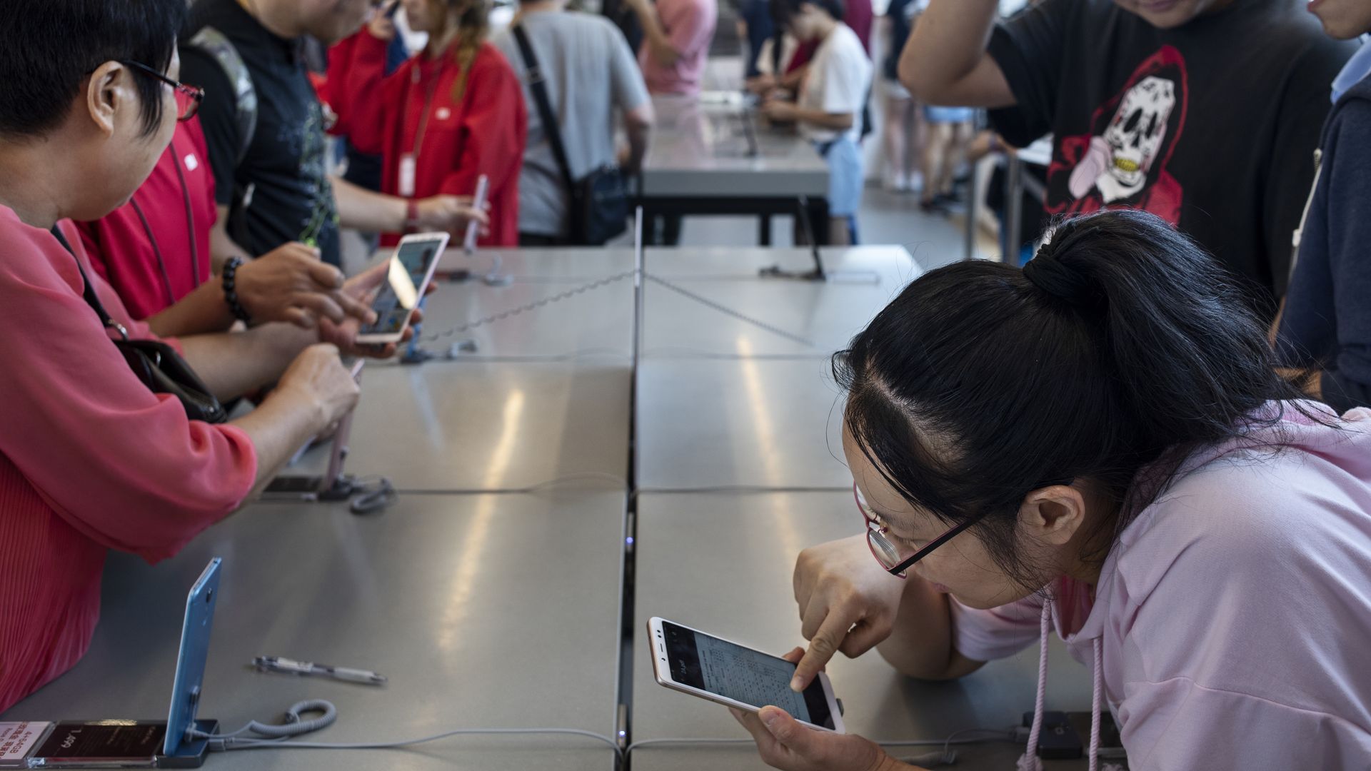 People look at smartphones at a store.