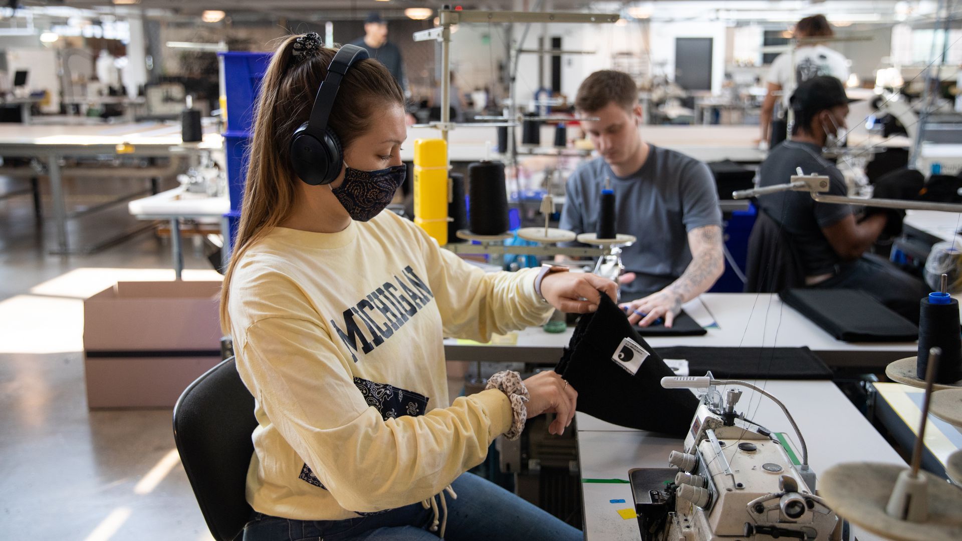 A worker inspects a Carhatt hat at the Industrial Sewing & Innovation Center manufacturing facility in Detroit. 