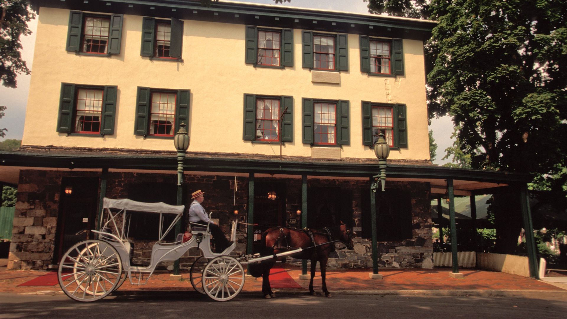 A horse-drawn carriage is parked outside the Logan Inn.