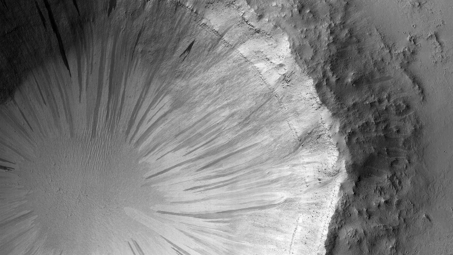 A black and white photo of a crater on Mars