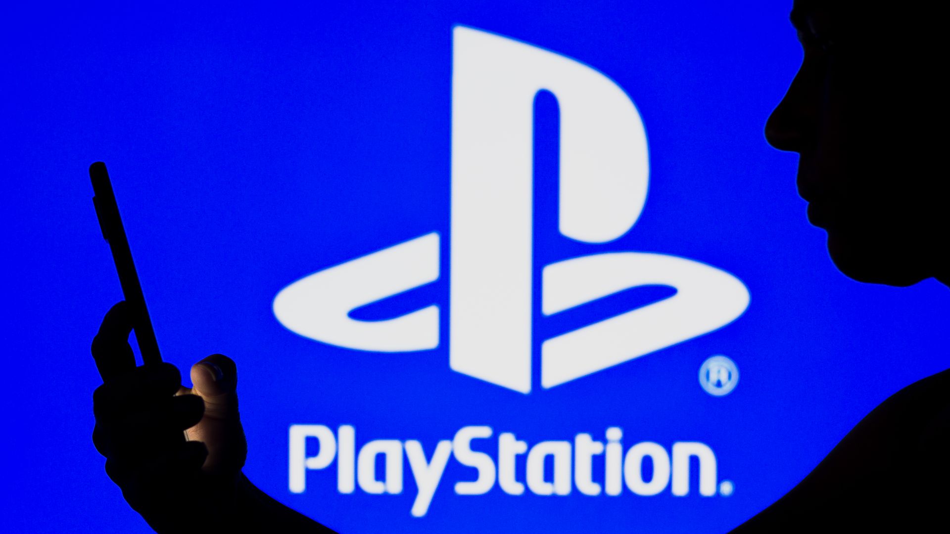 Image of the PlayStation logo and a woman seen in silhouette 