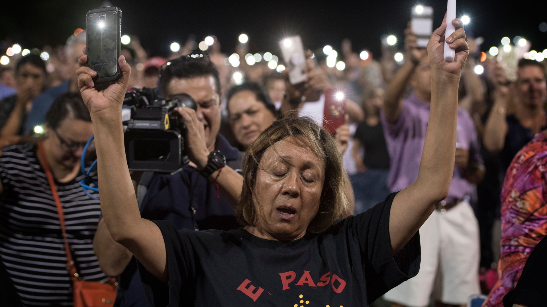 People react during a prayer vigil organized by the city.