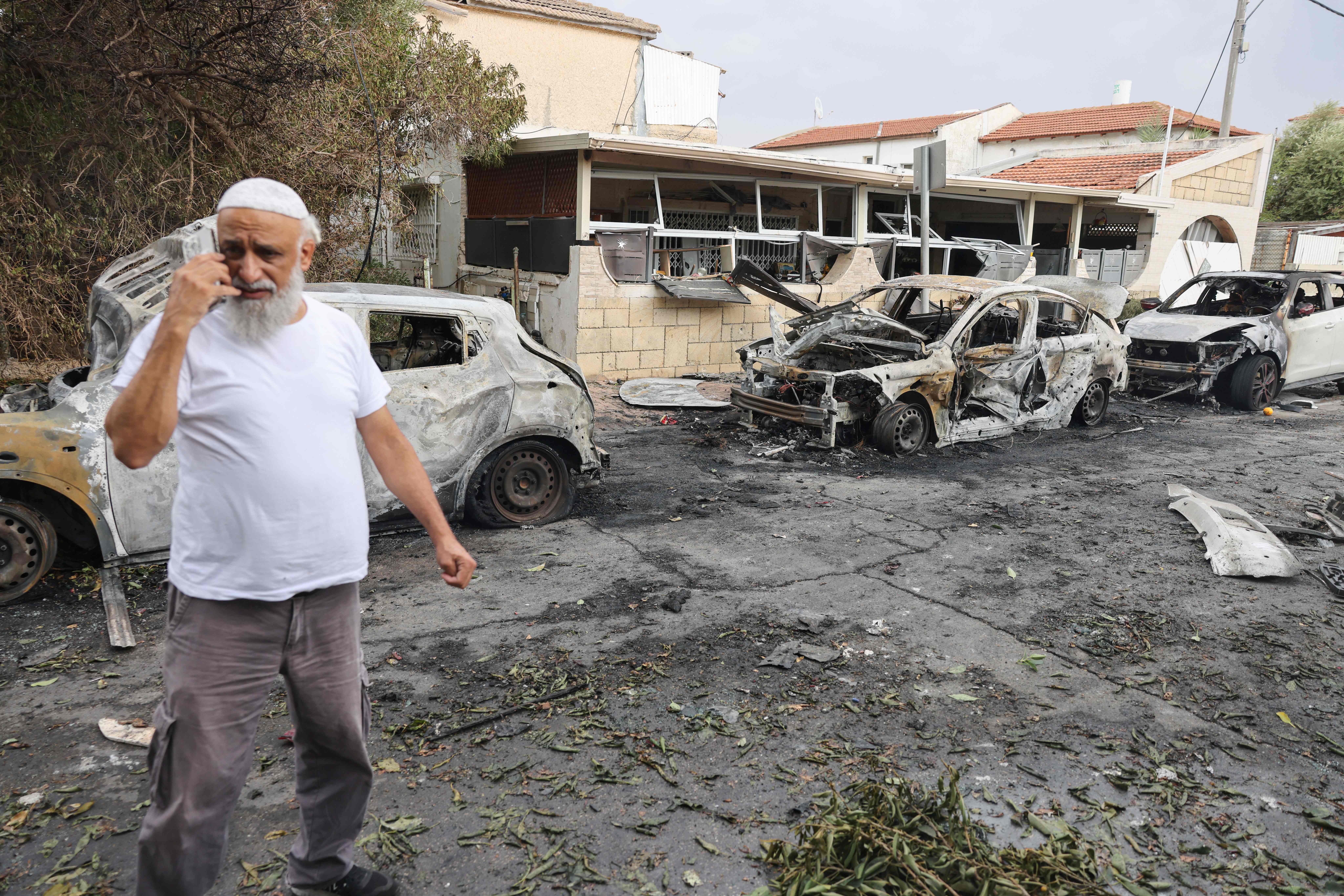 A man inspects the damage in the southern Israeli city of Ashkelon after a rocket attack from Gaza on Oct. 9. Photo: Menahem Kahana/AFP via Getty Images