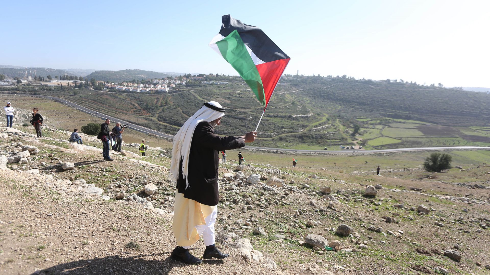 A Palestinian man waves Palestinian flag.