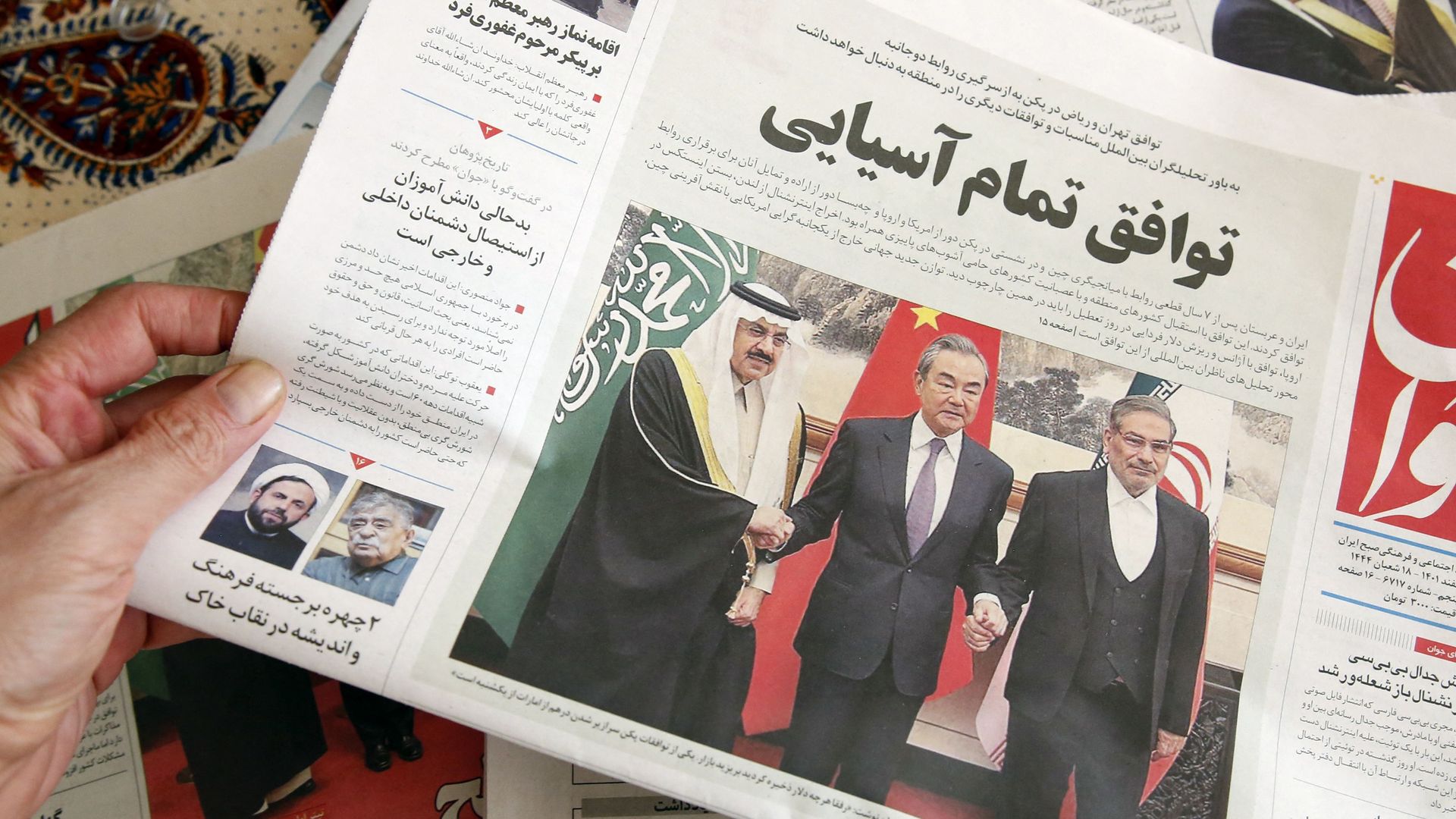 A man in Tehran holds a local newspaper reporting on its front page the China-brokered deal between Iran and Saudi Arabia to restore ties, signed in Beijing the previous day, on March, 11 2023. 