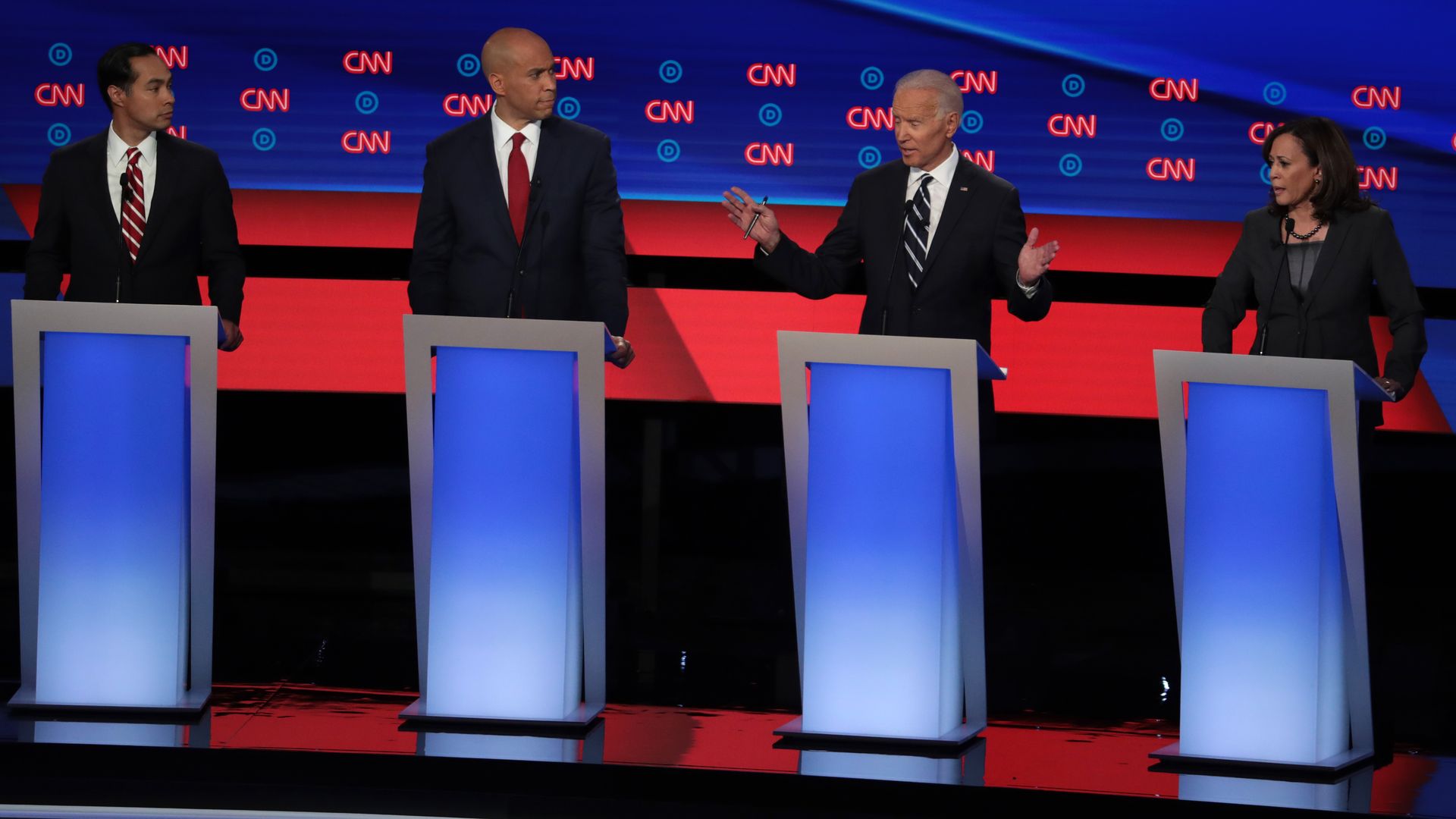 In this image, Castro, Booker, Biden, and Harris stand at podiums on the CNN stage on debate night.
