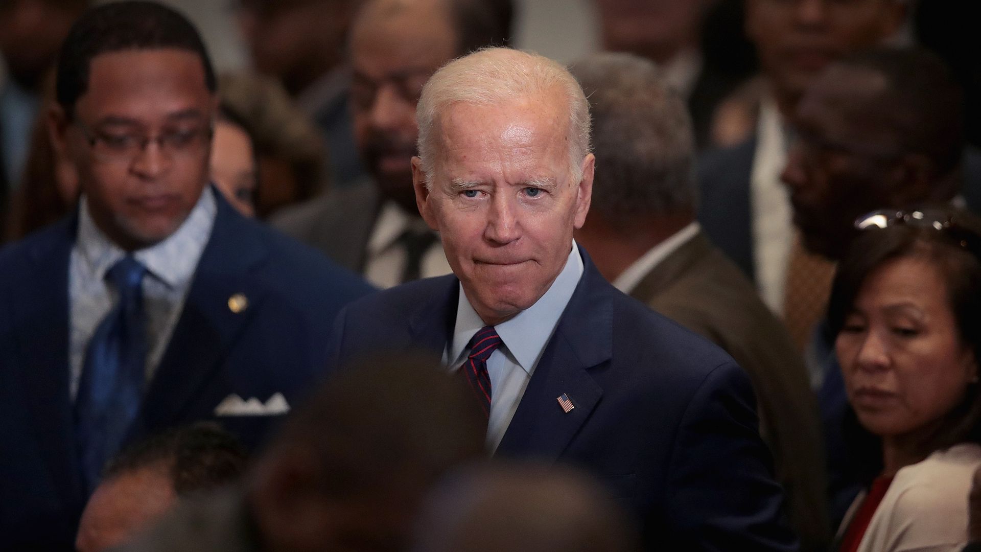 In this image, Biden stands in a crowd. 