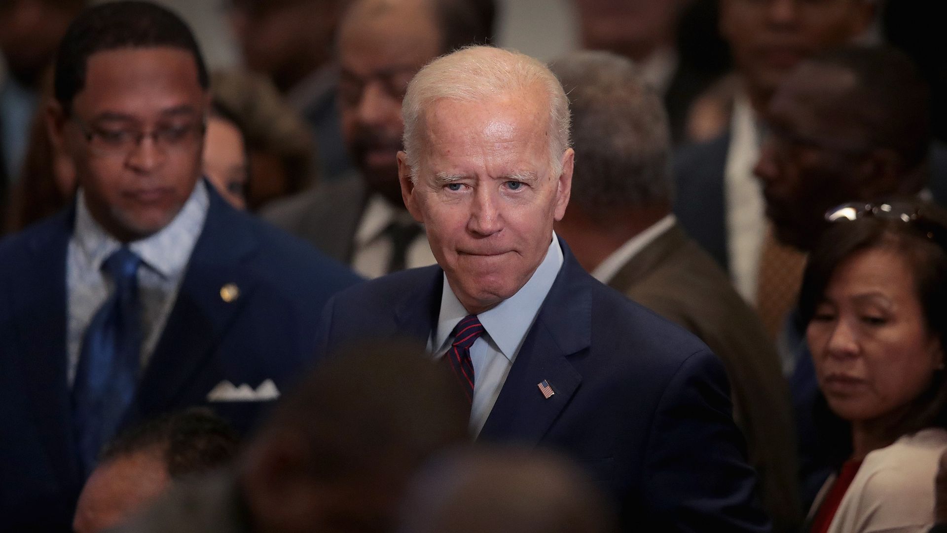 In this image, Biden stands in a crowd.