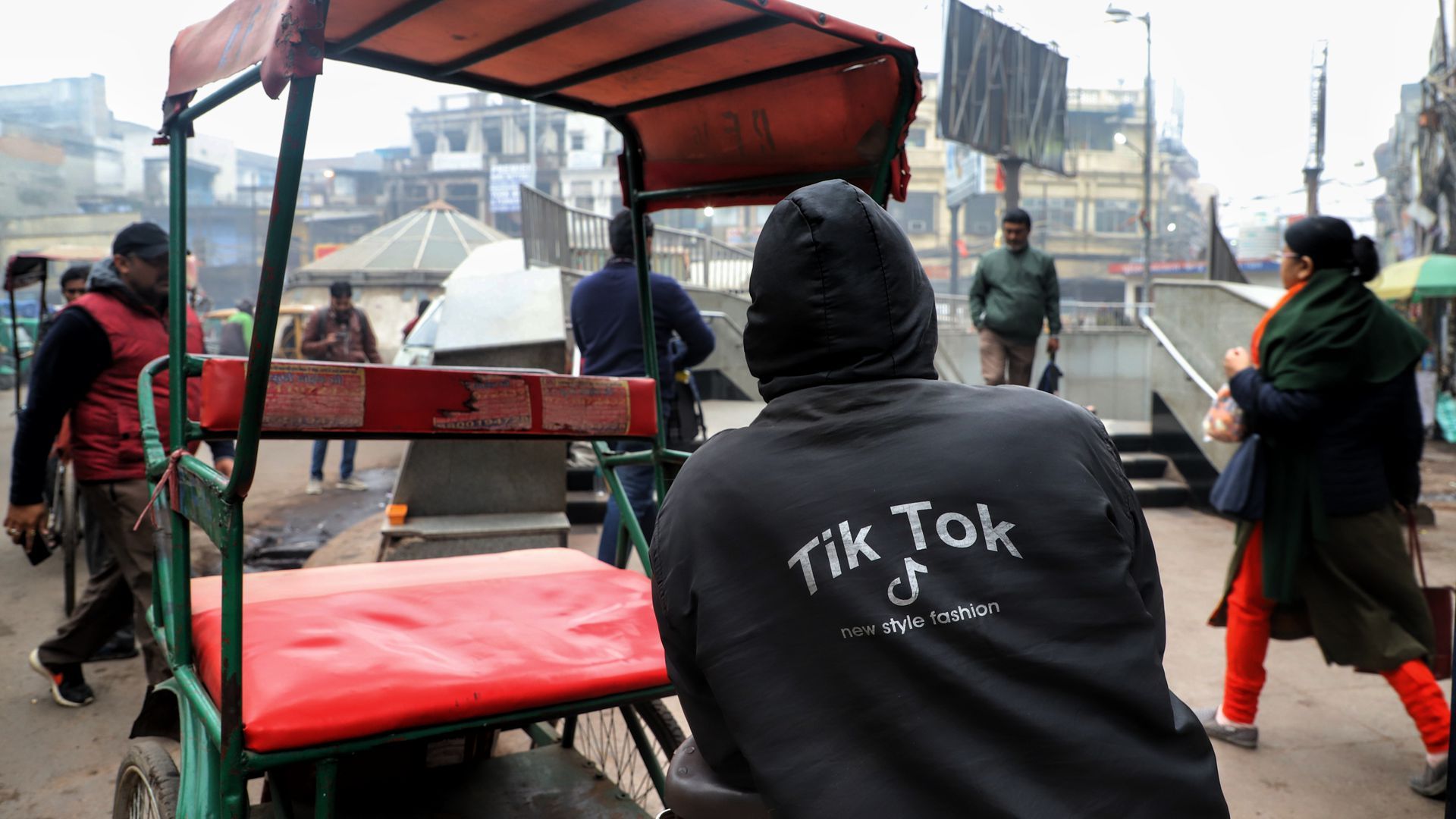 Rickshaw driver in New Delhi wearing a TikTok sweatshirt. 