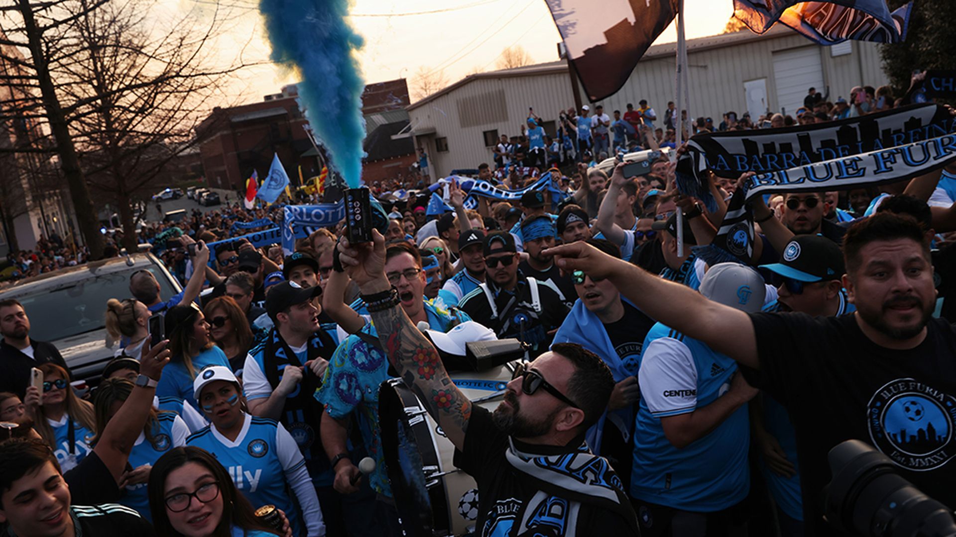 Supporters march toward Charlotte FC’s inaugural home match at Bank of America Stadium on March 5, 2022. Photo: Travis Dove/Axios