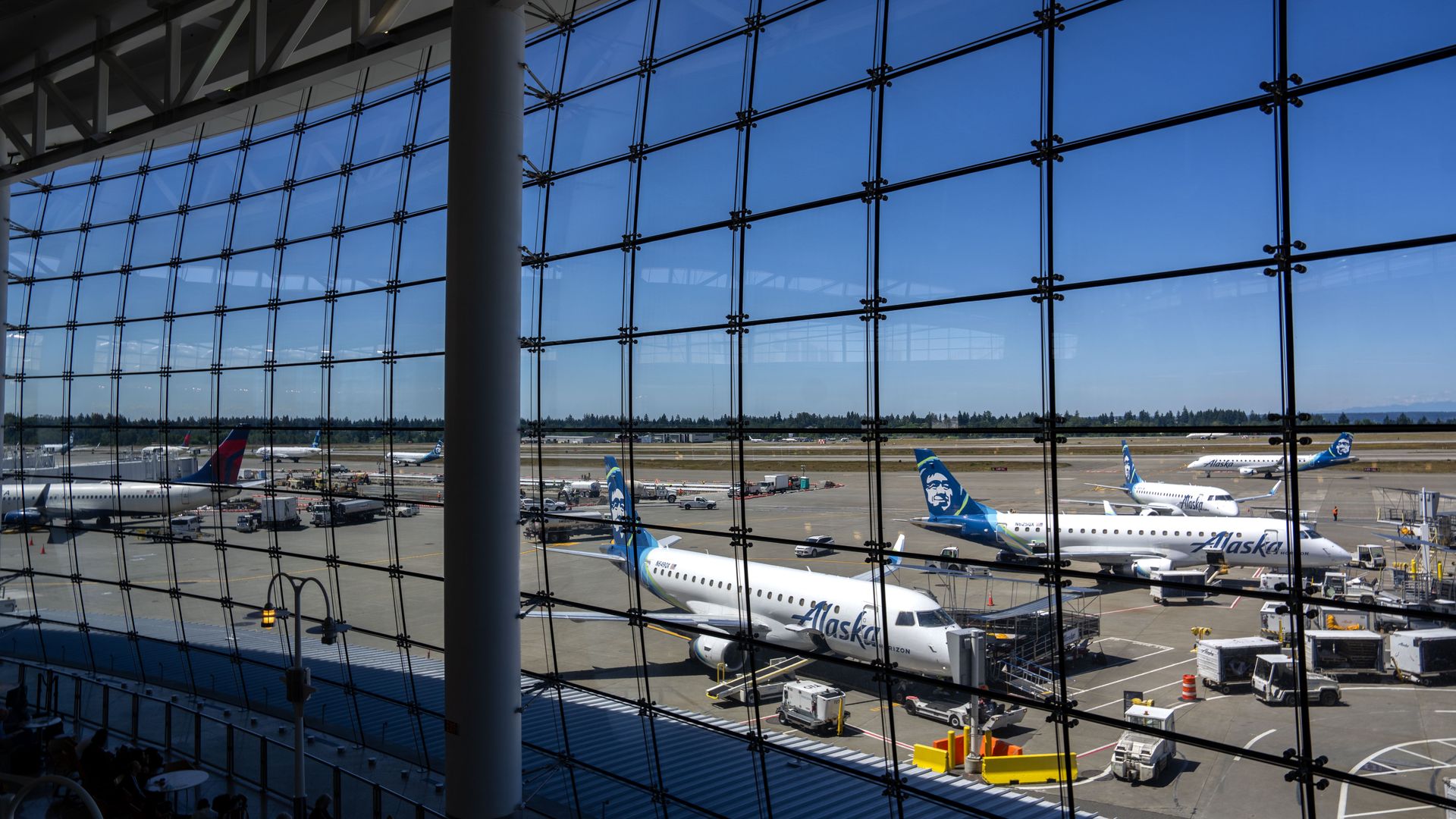 Windows look out over a field of airplanes.