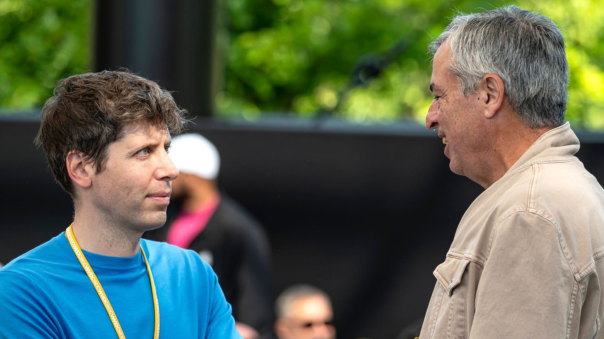 OpenAI CEO Sam Altman talks with Apple's Eddy Cue at an Apple event in June. 