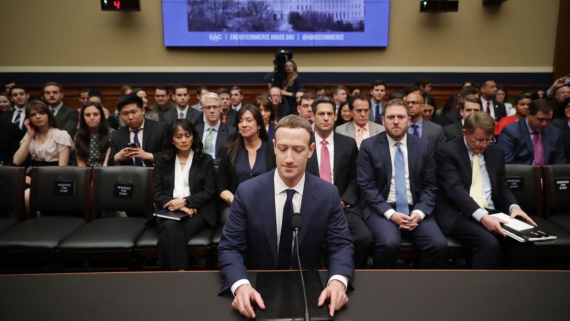 Mark Zuckerberg sits in front of spectators at one of his congressional hearings
