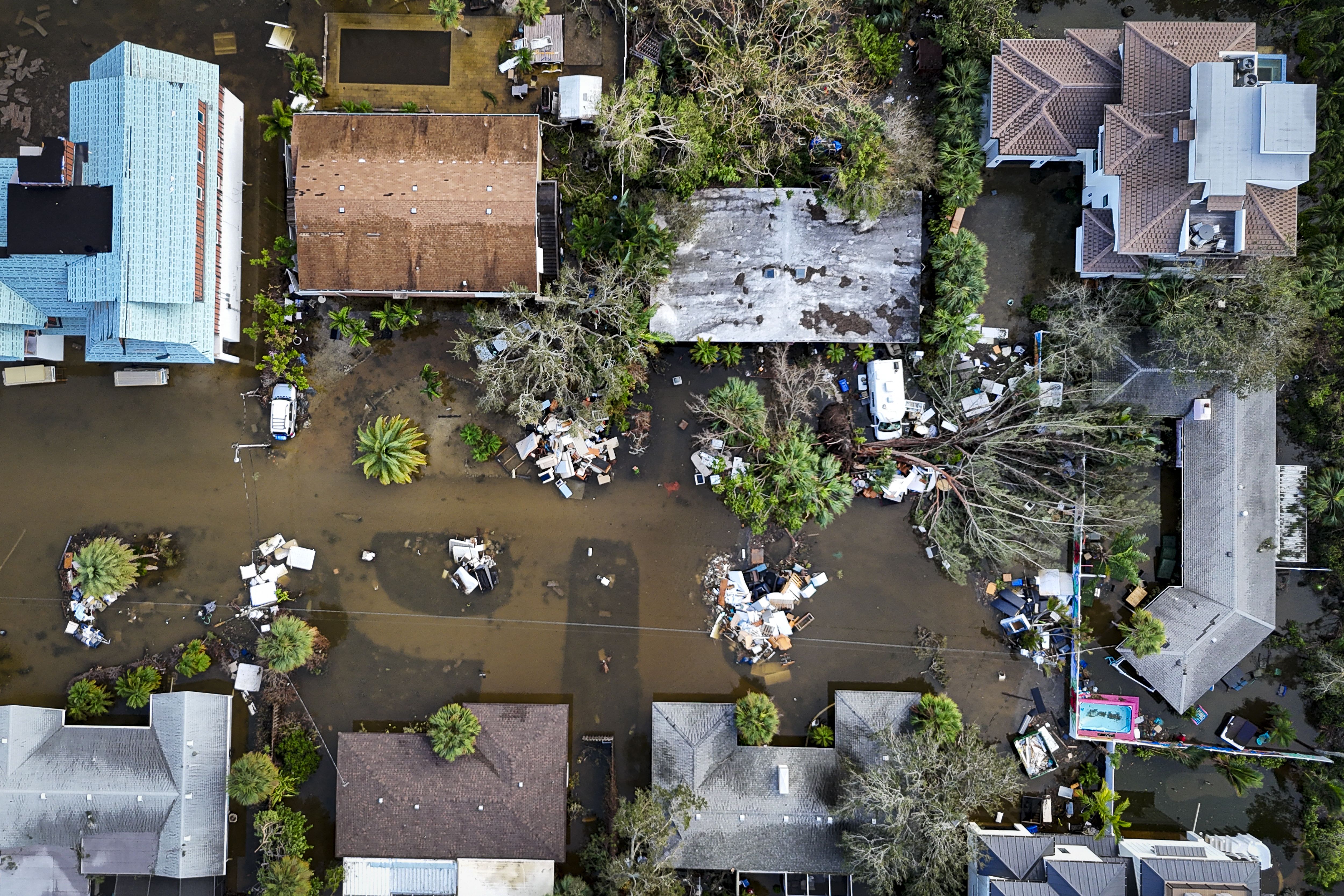 A drone image shows a flooded street due to Hurricane Milton in Siesta Key, Florida, on October 10, 2024. At least four people were confirmed killed as a result of two tornadoes triggered by Hurricane Milton on the east coast of the US state of Florida, local authorities said Thursday. (Photo by Mig