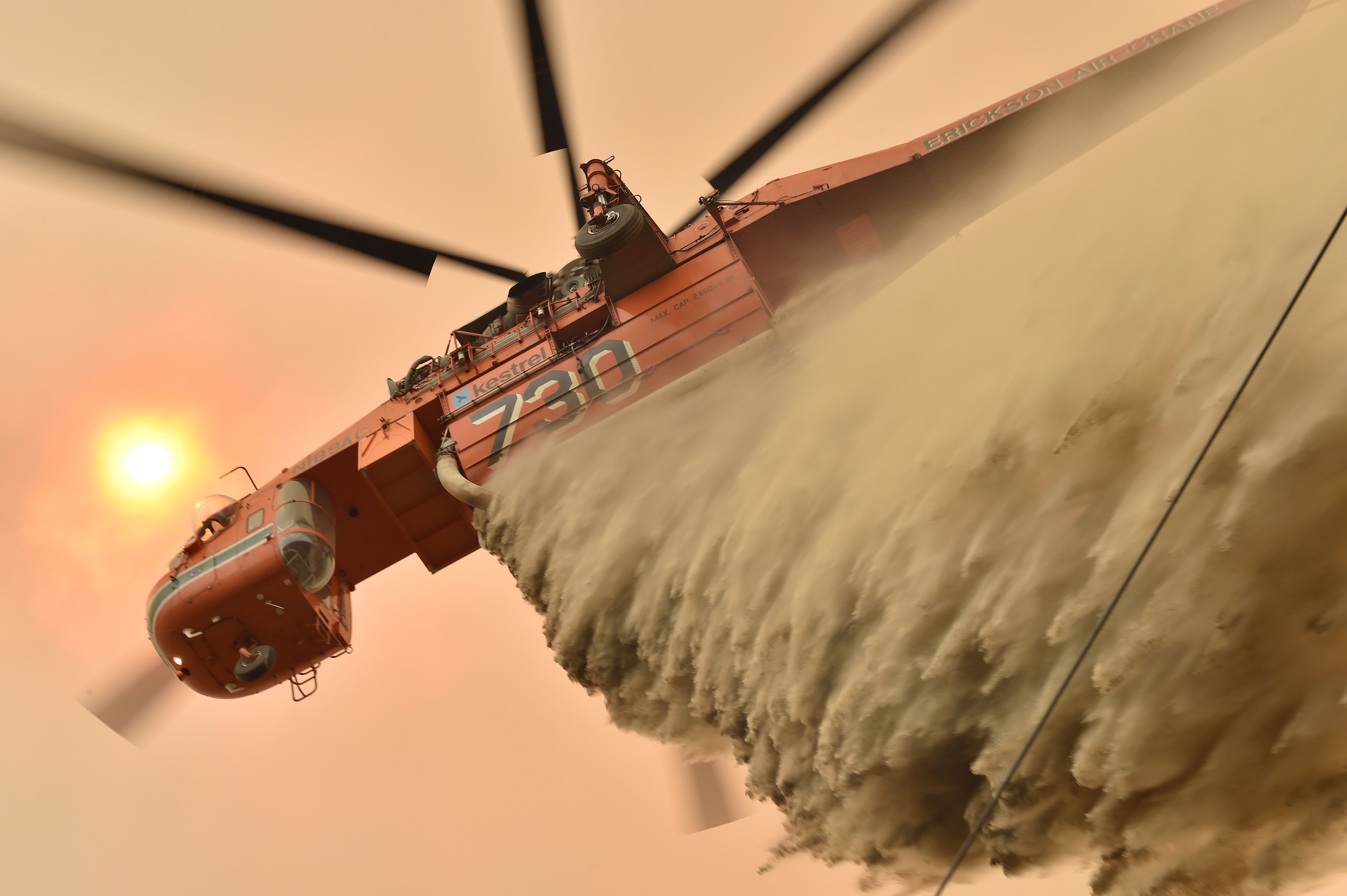 A helicopter drops fire retardent to protect a property in Balmoral.