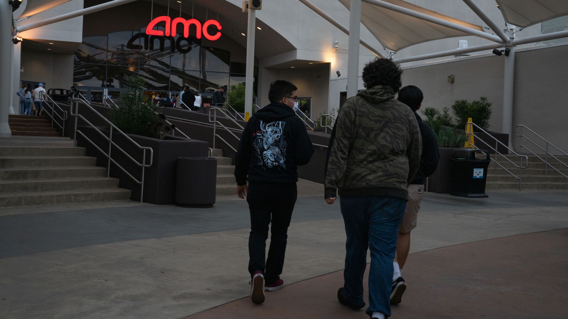 People walking into an AMC theater in San Diego in April 2021.