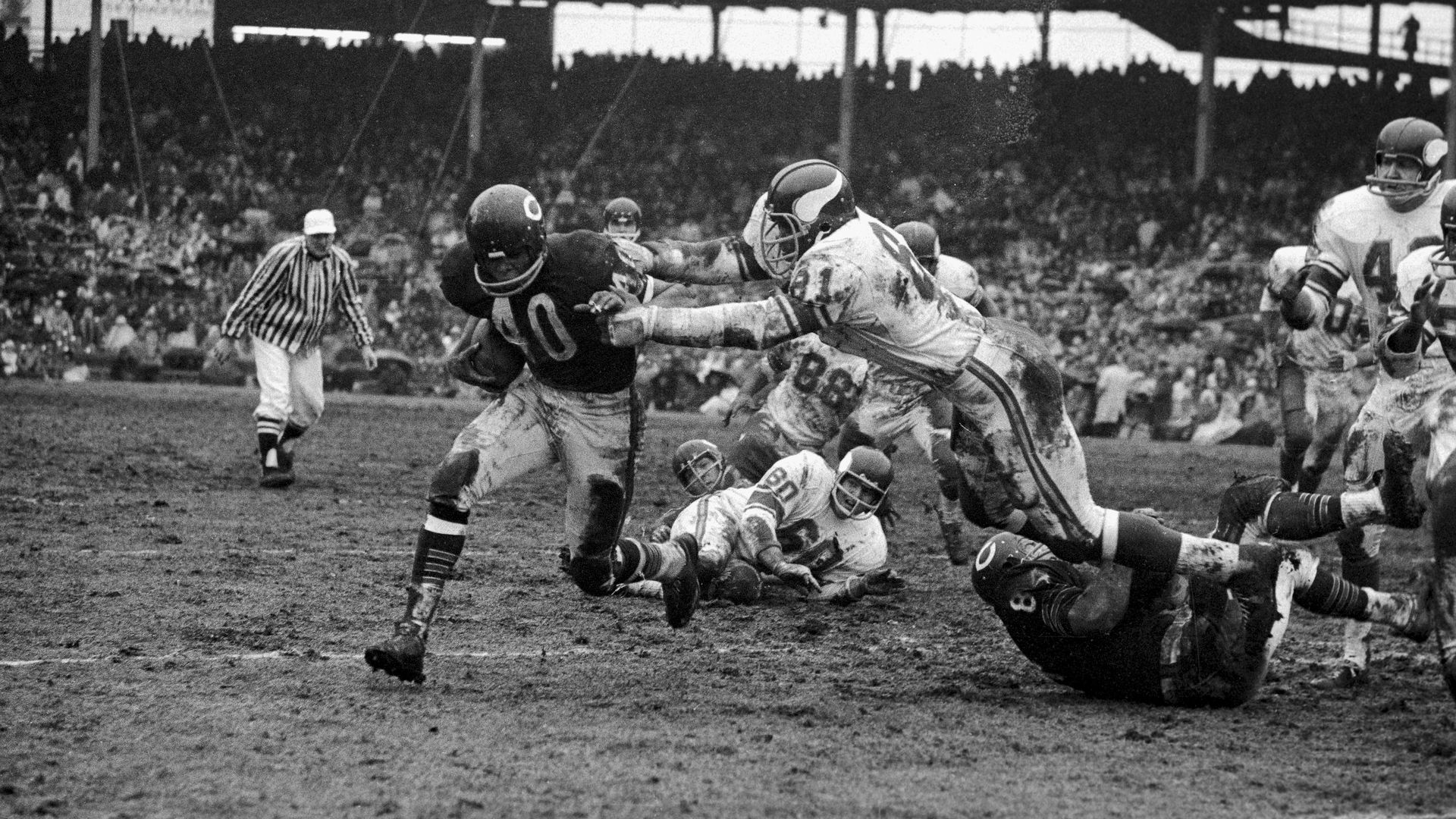 A photo of a football player breaking a tackle. 