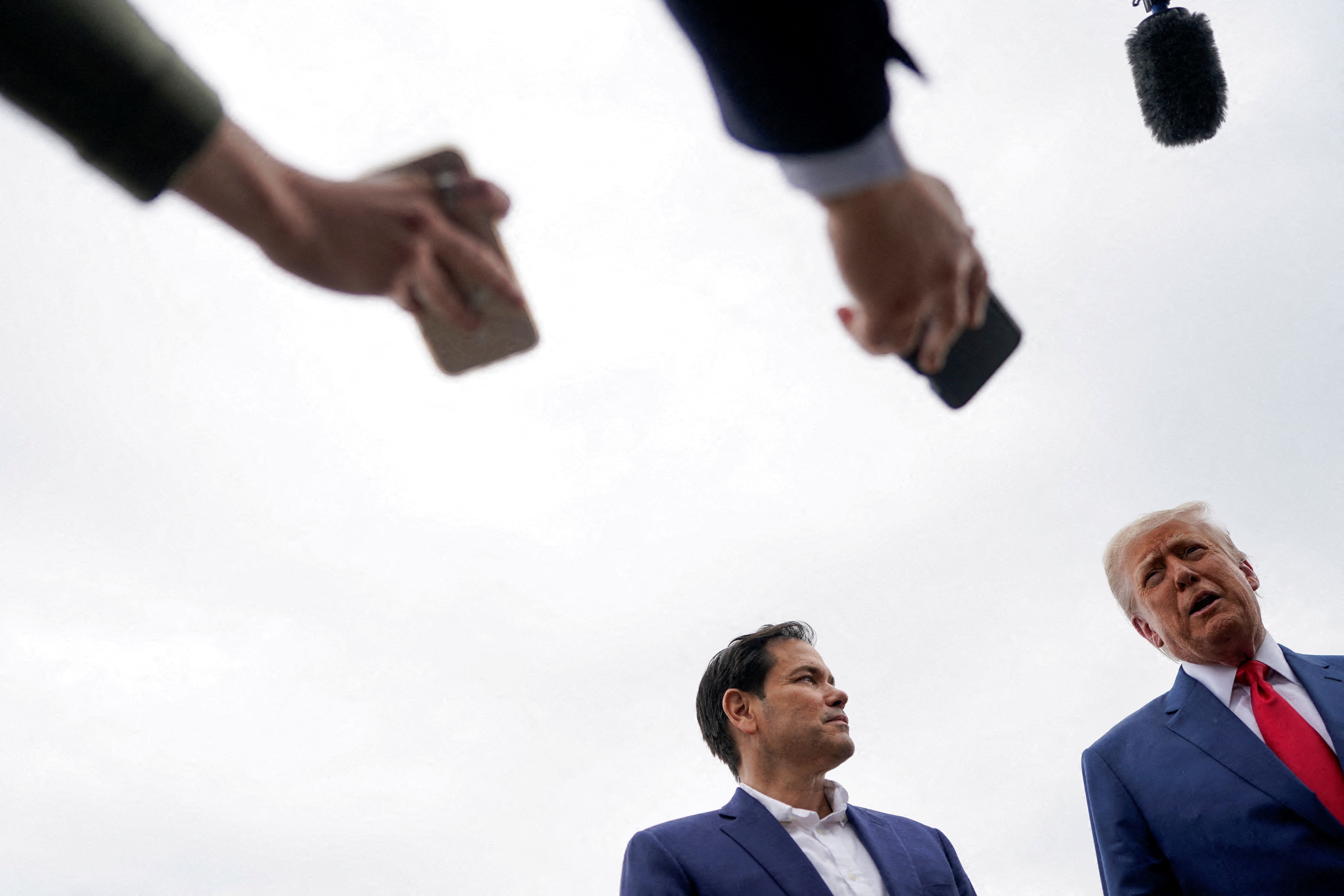 President Trump and Secretary of State Marco Rubio talk to reporters in New Jersey on Sunday before departing for Camp David.
