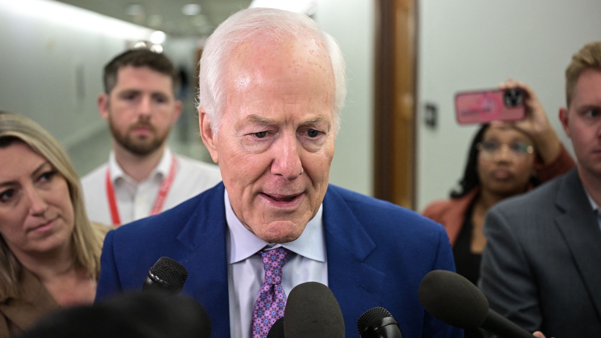 Sen. John Cornyn speaks with reporters outside a Senate hearing room on Capitol Hill in Washington.