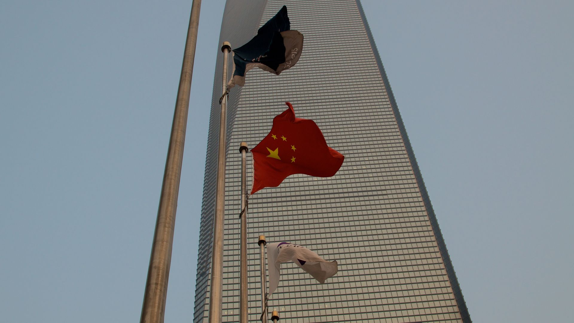  A Chinese flag flutters in front of the Shanghai World Financial Centre (SWFC). 