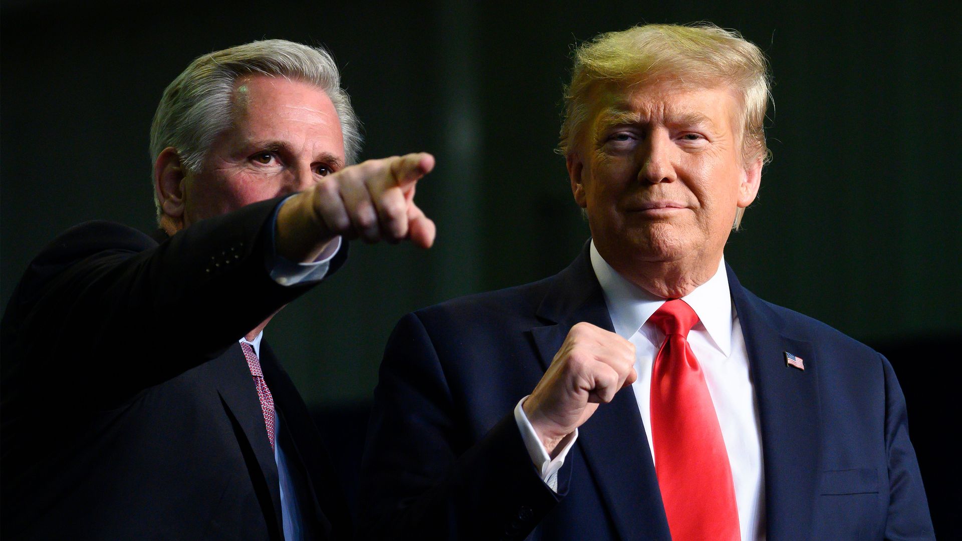 House GOP Leader Kevin McCarthy points a finger and then-President Donald Trump points his fist at a 2020 event