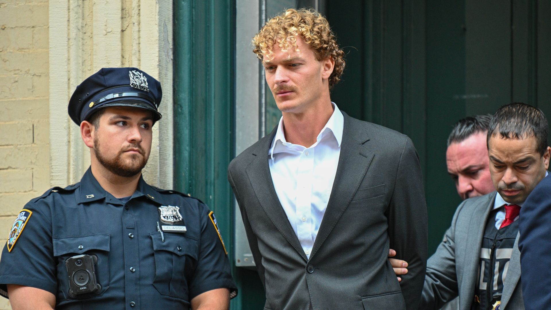 Daniel Penny is escorted in handcuffs by the NYPD after turning himself into the 5th Precinct on May 12 in New York City. 