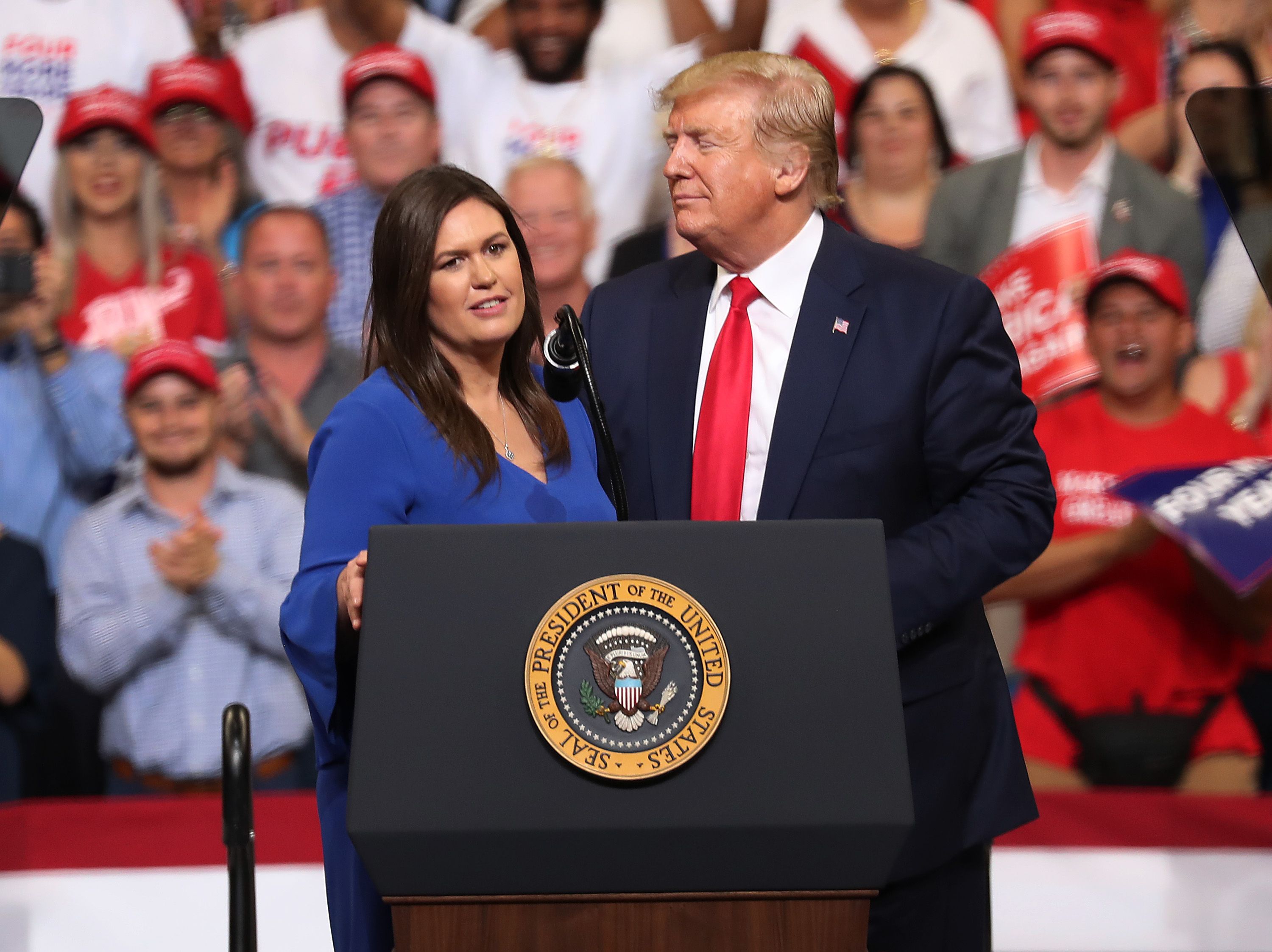 Trump stands with Sarah Huckabee Sanders, who announced that she is stepping down as the White House press secretary.