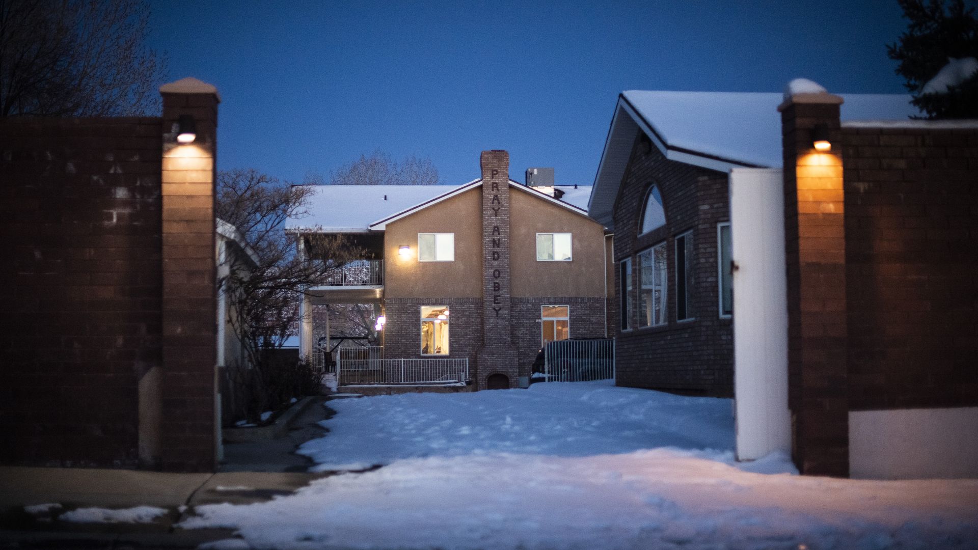 A chimney with the words "PRAY AND OBEY" at a compound.