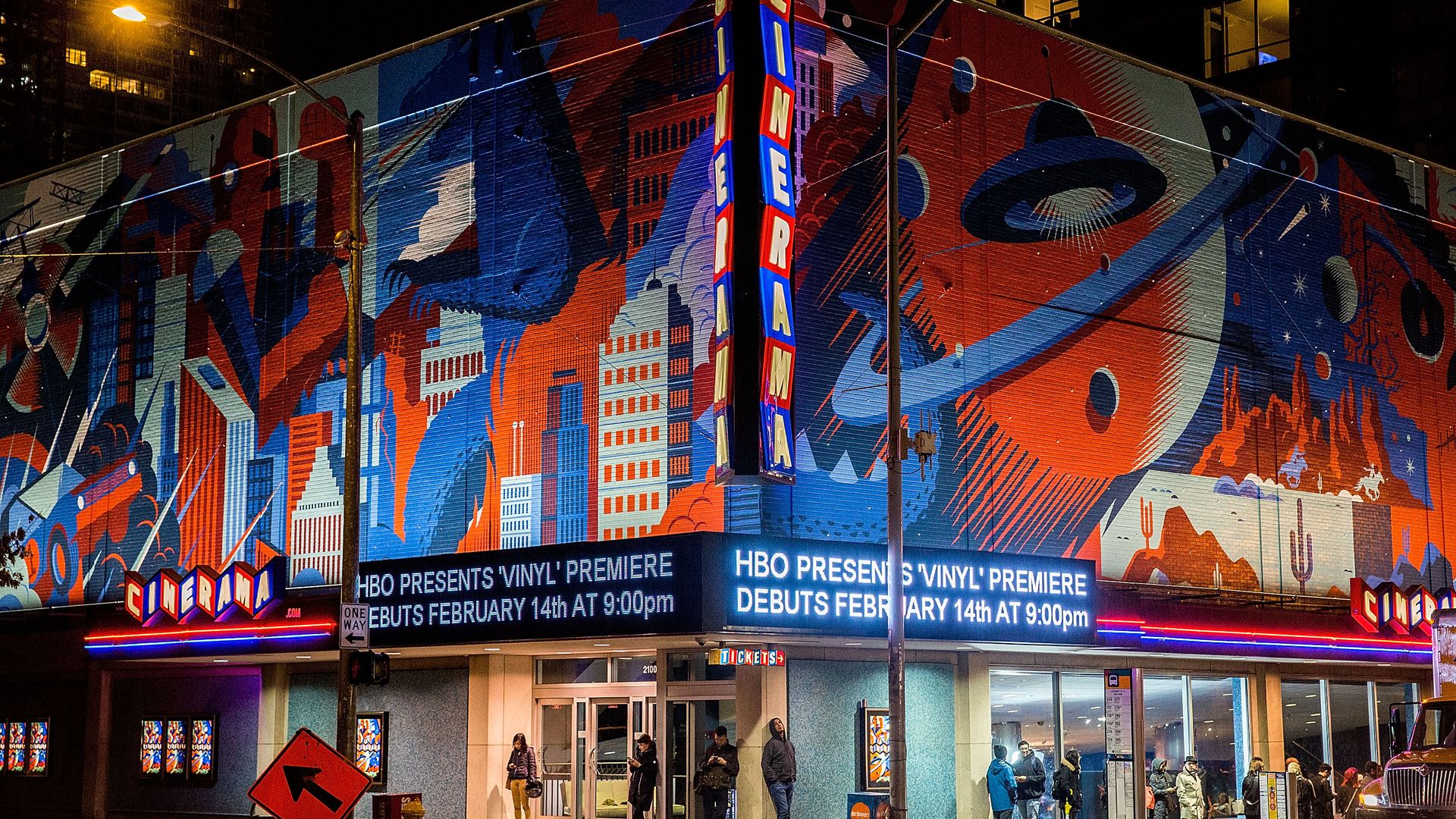 An image of the former Cinerama theater in Seattle with brightly painted murals. 