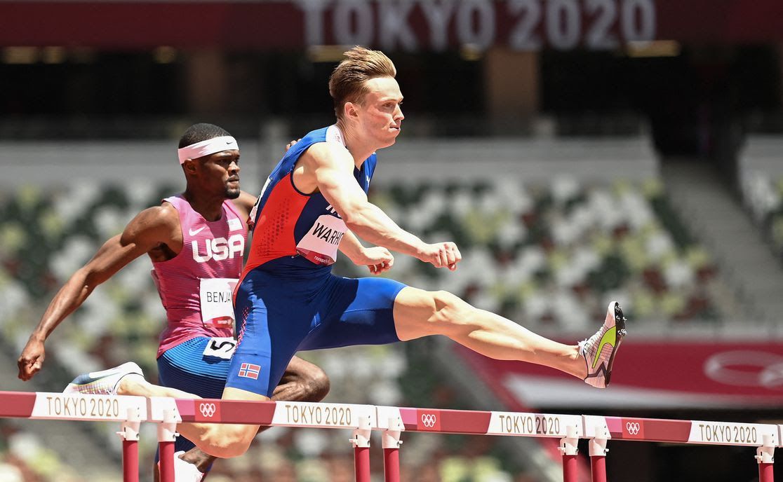 Image showing runners go over hurdles at Tokyo 2020.