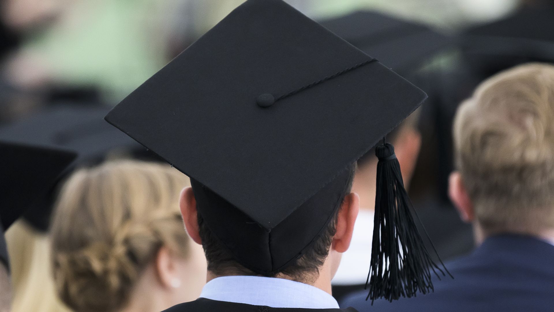 raduates sit in a tent on the premises of the University of Mannheim during a Master's graduate party. Photo: Silas Stein/dpa (Photo by Silas Stein/picture alliance via Getty Images)