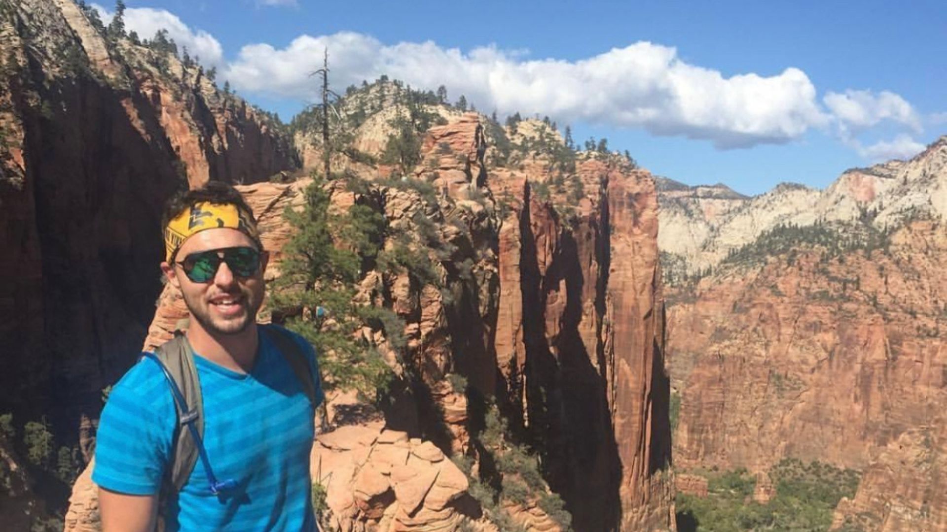 A man in front of some mountains.