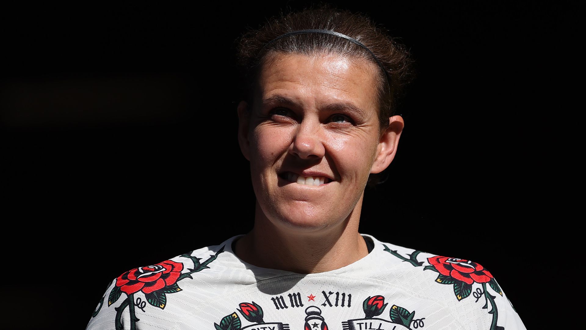 A photo of a person smiling with a shirt that says "Rose City 'Til I Die"