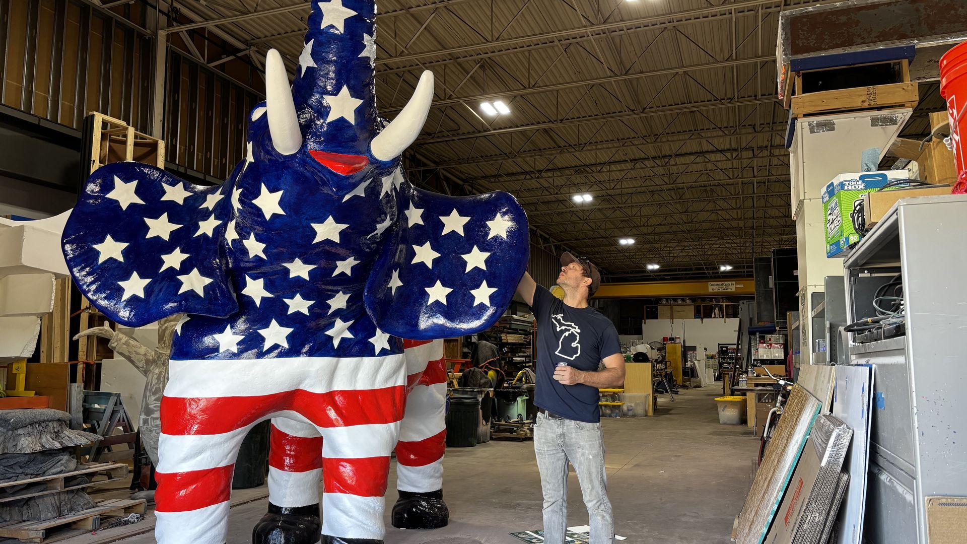 Kaelin Stockwell, who worked on Tammy's restoration team, applies some paint to the elephant.