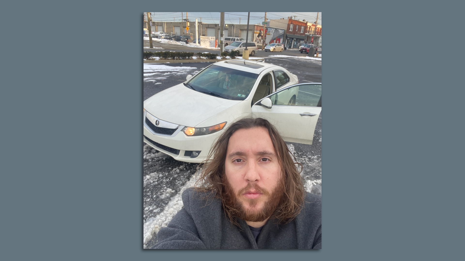 Michael Grant AKA "Philly Jesus" standing in front of his Acura.