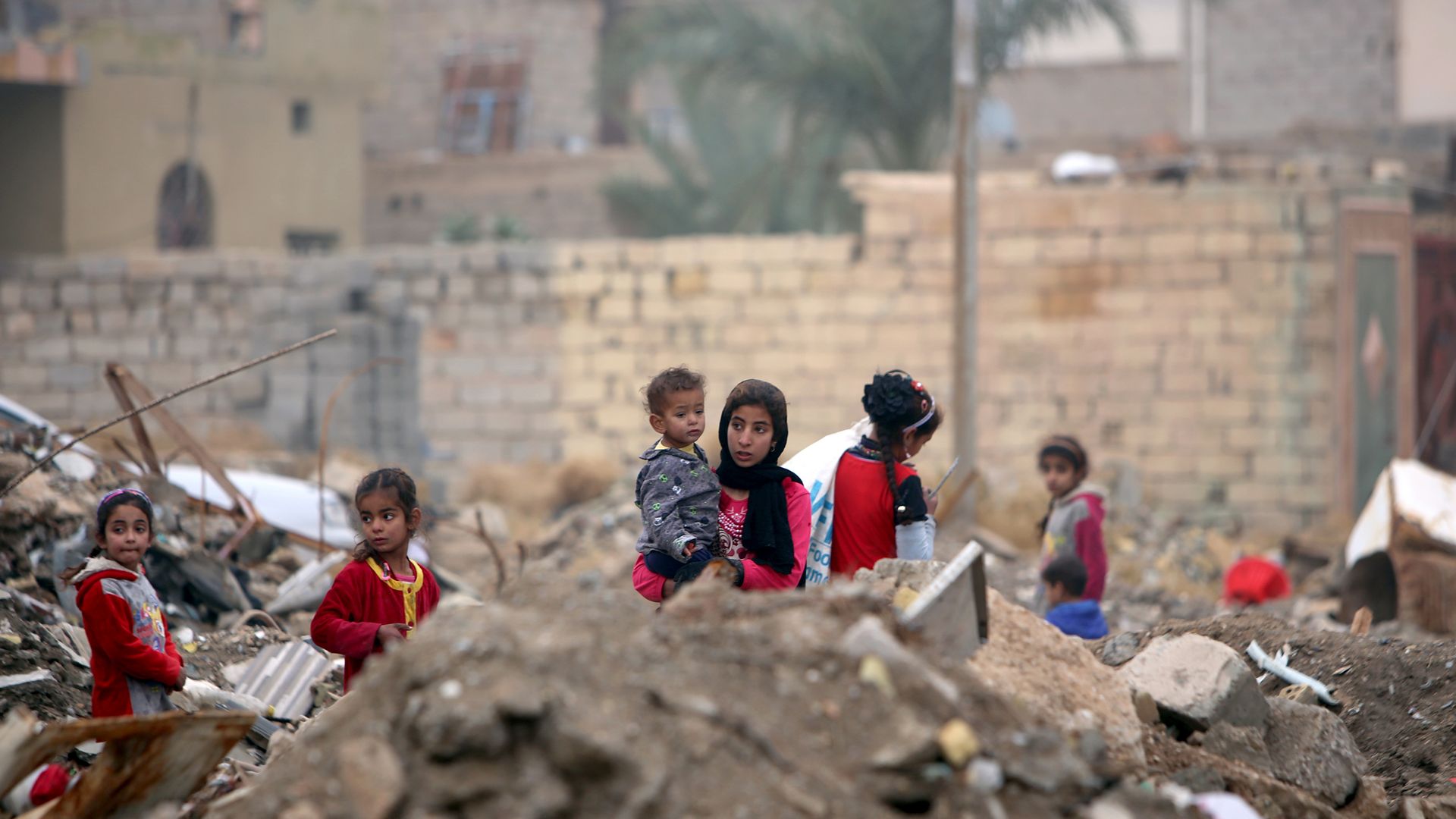 Children stand amid rubble in Fallujah, Iraq.