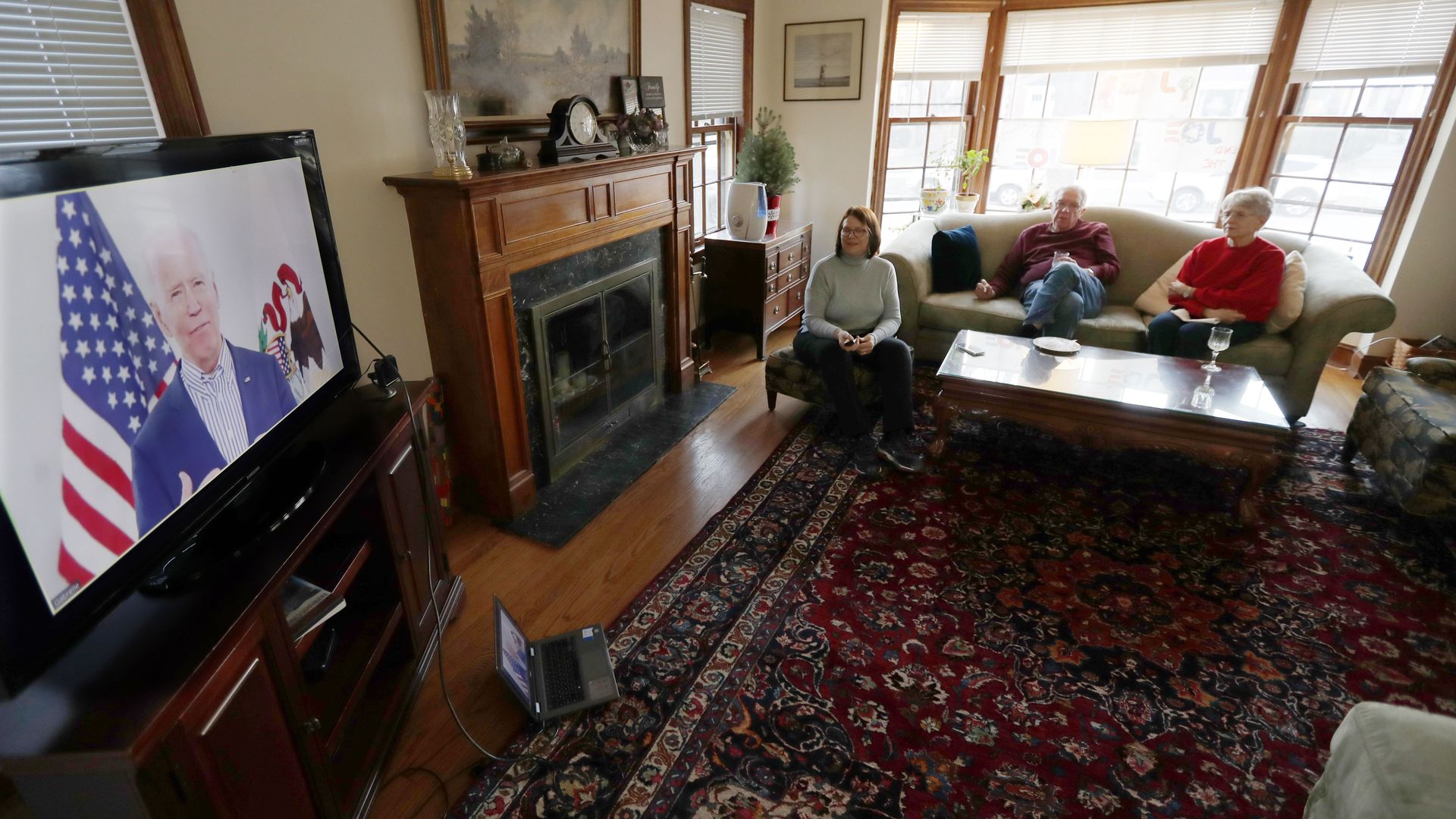 In this image, Biden is displayed on a TV in a living room