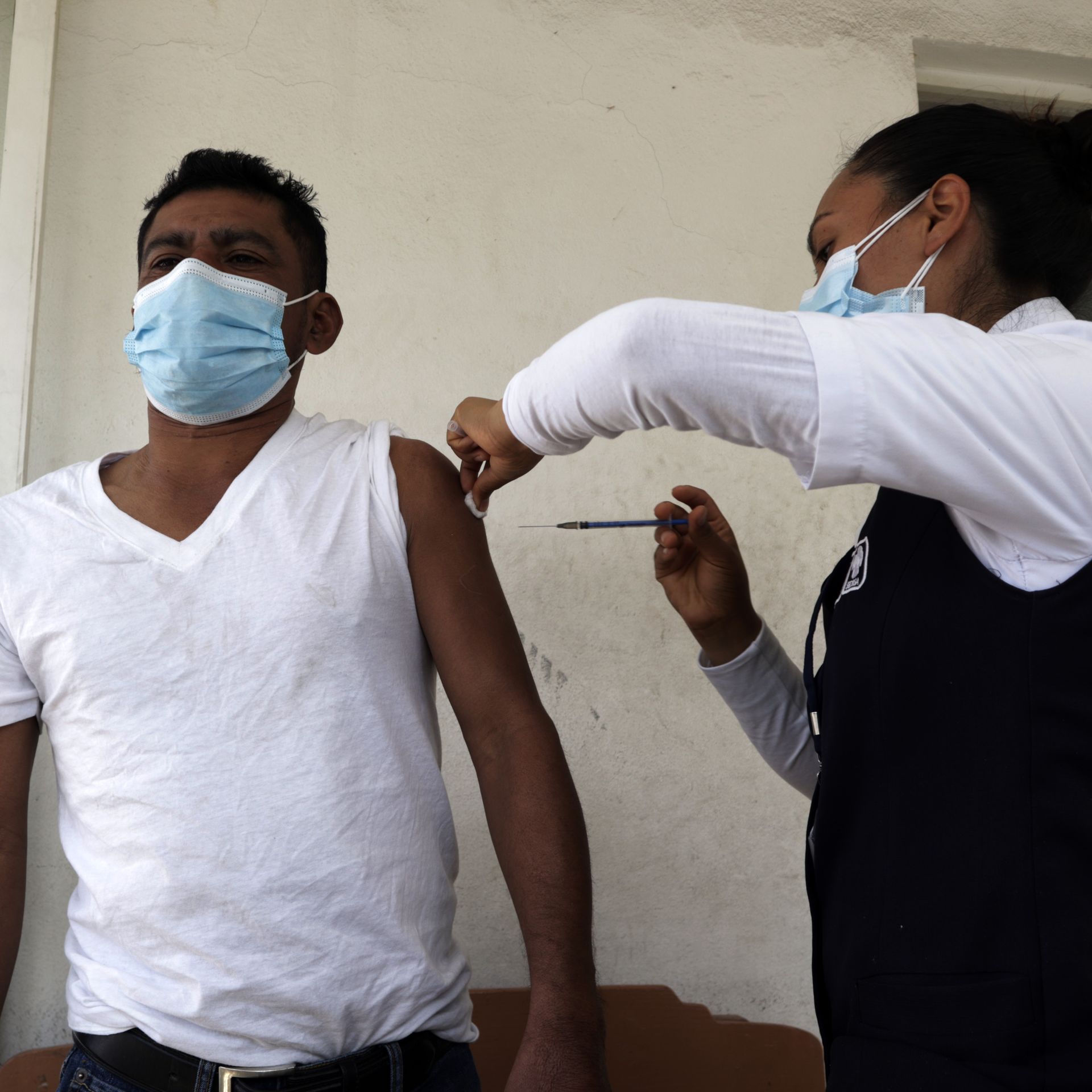 A migrant receives a vaccine dose in Mexico before continuing their journey to the U.S. border
