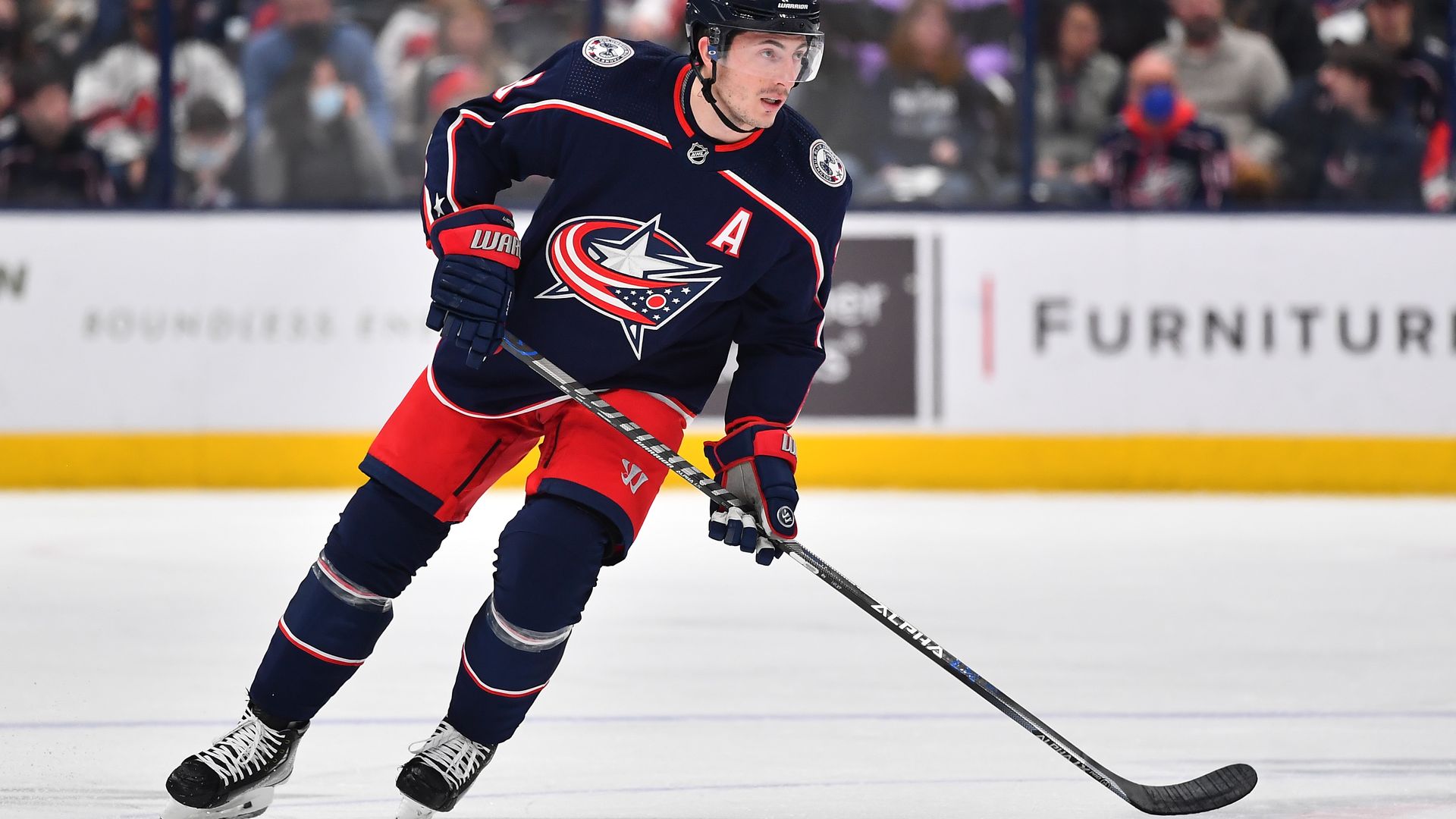 Columbus Blue Jackets hockey player Zach Werenski skates on the ice.