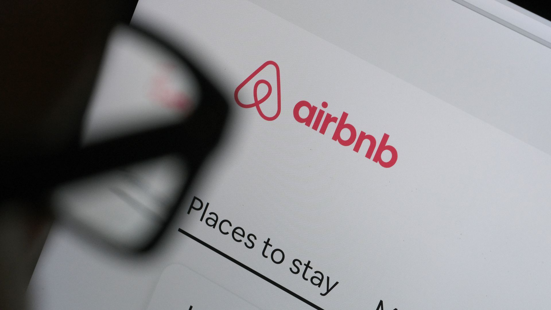 A picture of someone looking at an Airbnb web page through eyeglasses