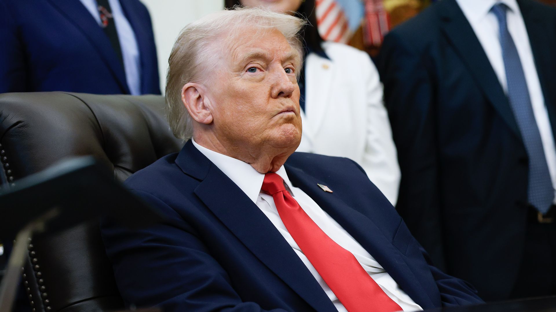 President Donald Trump listens to other speakers after delivering remarks during an event in the Oval Office 