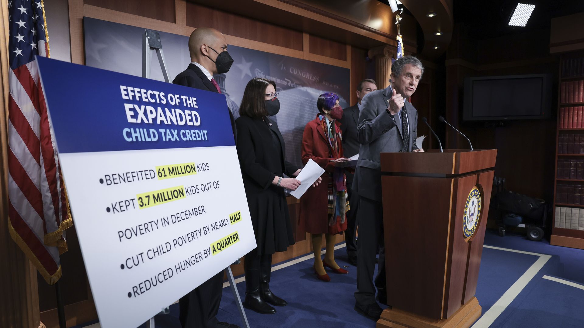 Democrats with sign about child tax credit