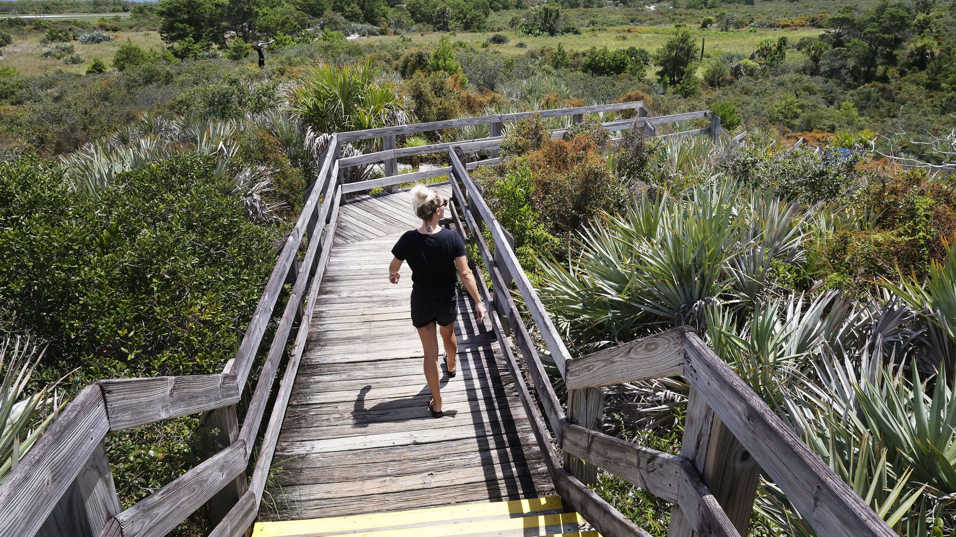 A woman walking down a pathway.