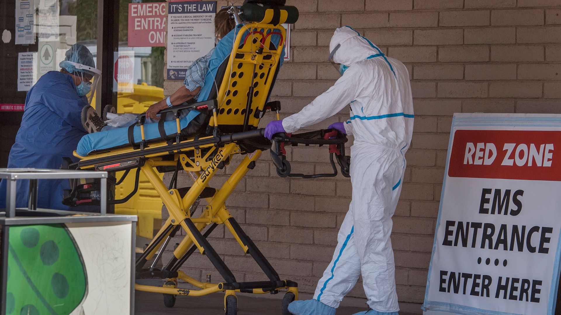 A patient is taken from an ambulance to the emergency room of a hospital in the Navajo Nation town of Tuba City