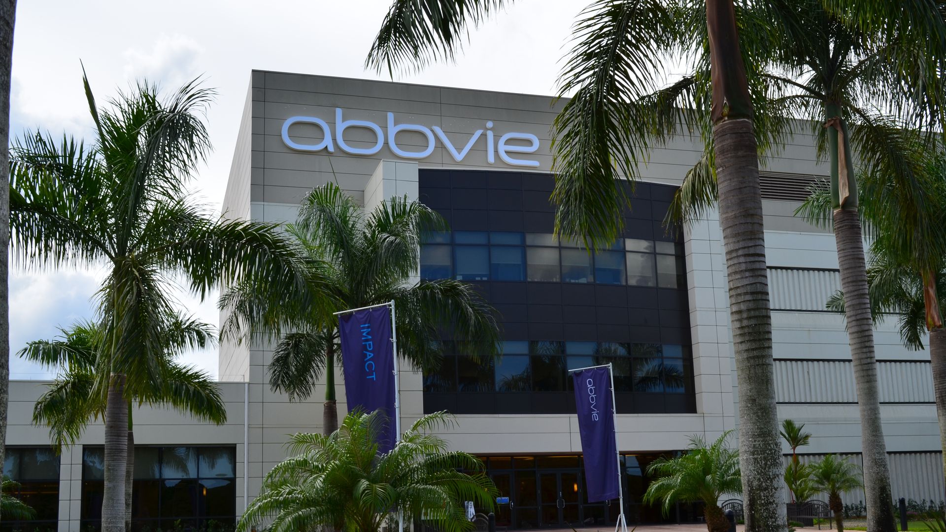 A building with the AbbVie logo and palm trees in the foreground.
