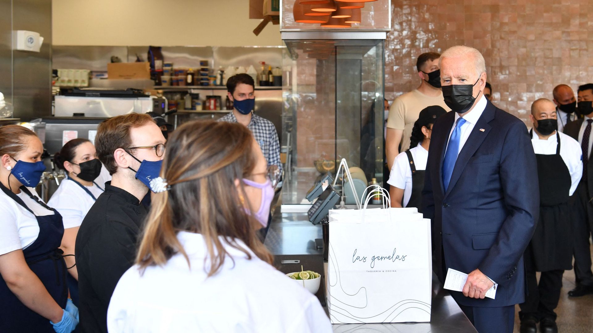 President Biden surrounded by workers at Las Gemelas Taqueria in 2021.